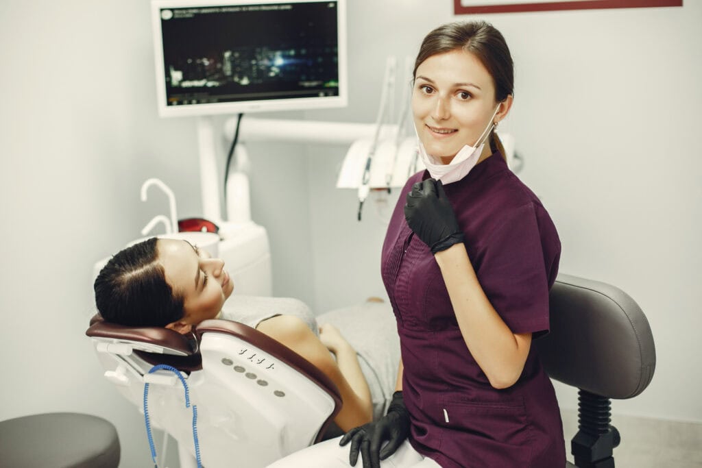 smiling-woman-at-dentist-after-arch-dental-implants